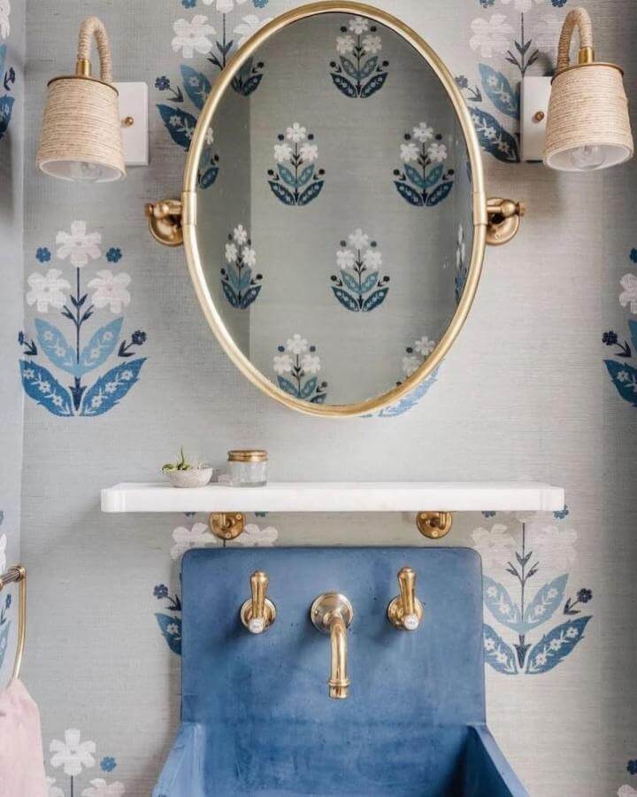 Light blue bathroom ideas featuring floral wallpaper, blue sink, and gold fixtures from @veronicazimbaro showcasing vintage charm.