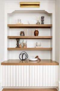 Minimalist harmony achieved with textured white cabinetry in living room built ins ideas.