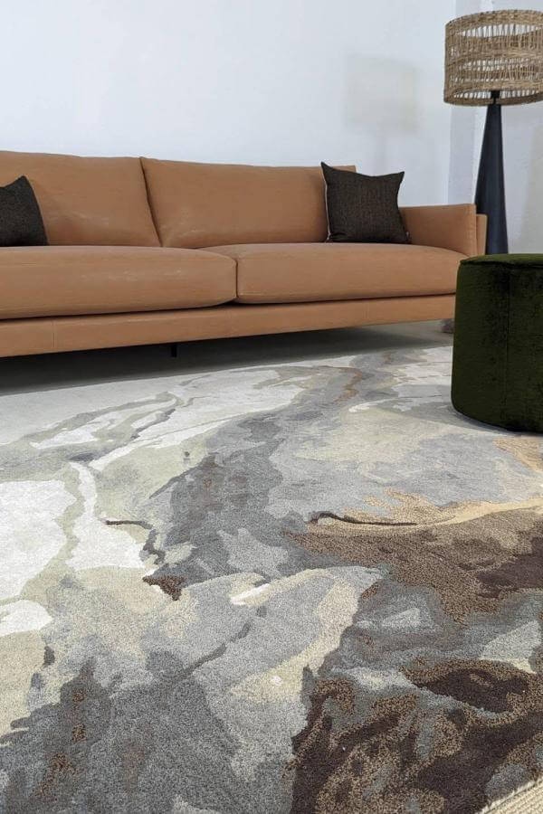 Abstract earth tones rug enhances cozy aesthetic; perfect living room rug ideas.