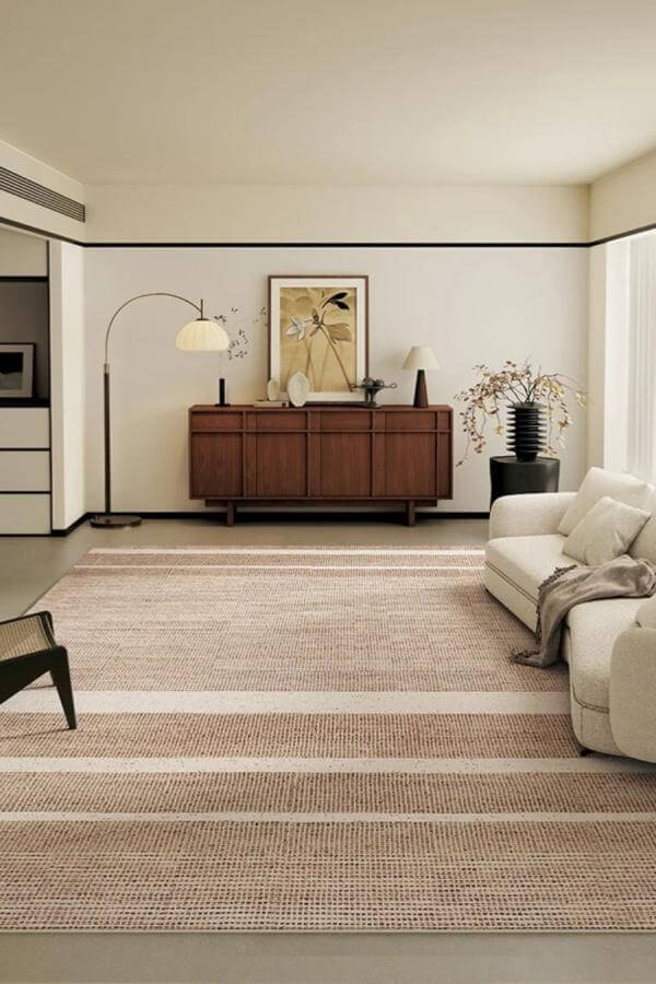 Alt text: Soft neutral striped rug for textured tranquility in living room rug ideas.