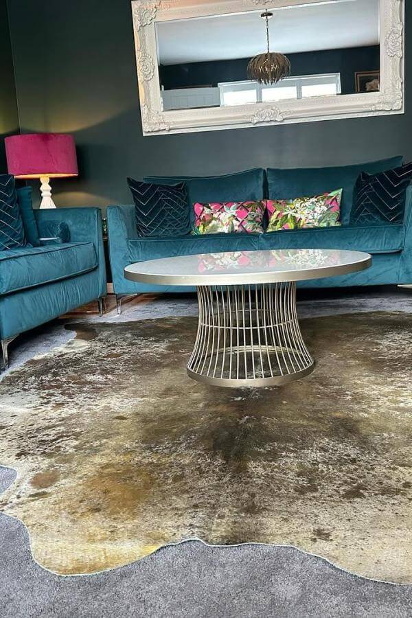 Teal opulence and rustic charm blend in this living room rug idea.