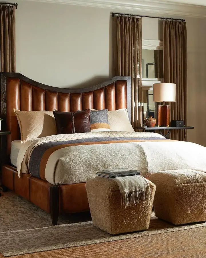 Rich cognac leather bed frame from @hancockandmoore. Features dramatic curved headboard with channeled upholstery detailing.