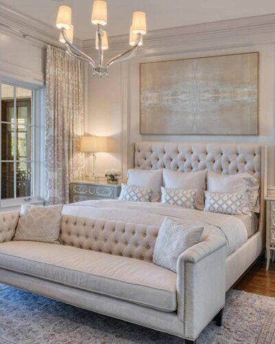 Neutral tufted bedroom showcasing luxurious master bedroom ideas from @monicawilcoxinteriors. Features matching headboard and bench.