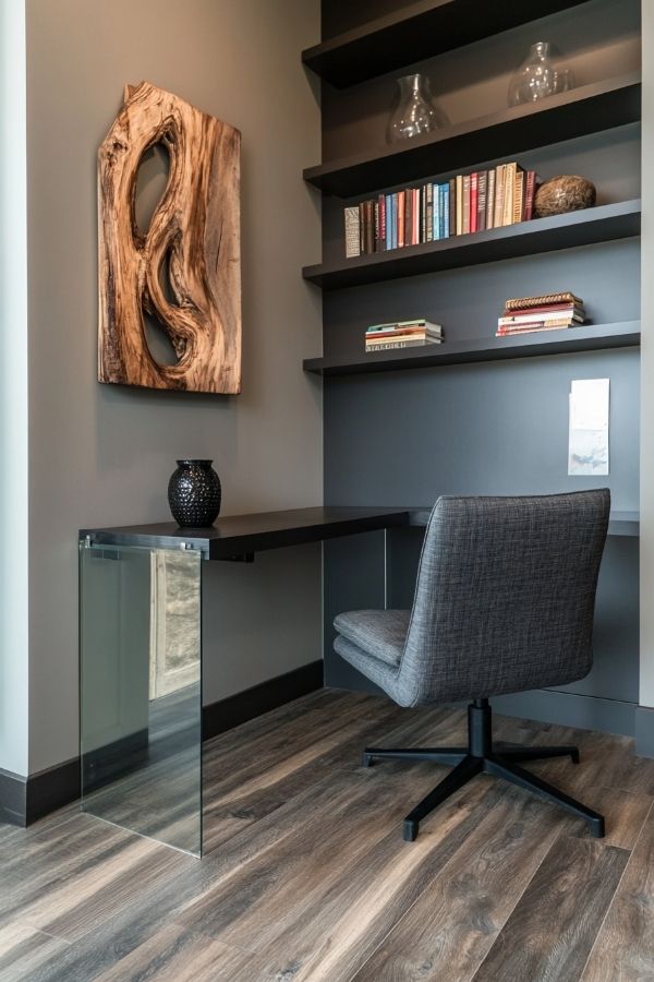 Masculine home office featuring dark wood desk, leather chair, vintage decor.