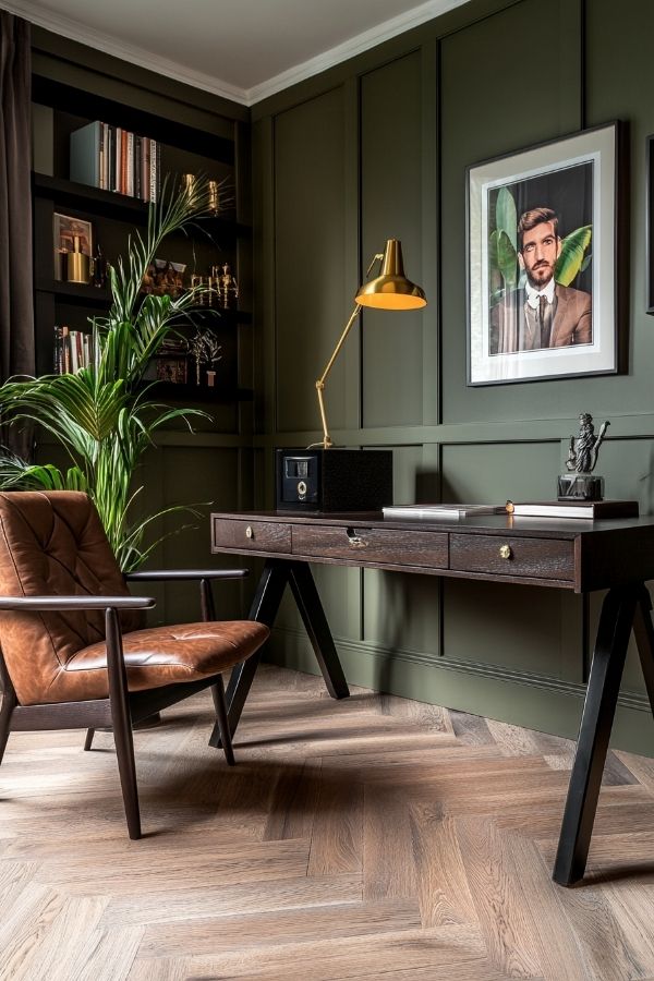 masculine home office featuring dark wood desk, leather chair, and bookshelves