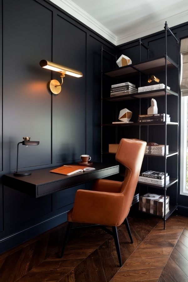 Masculine home office with dark wood desk, leather chair, and bookshelves.