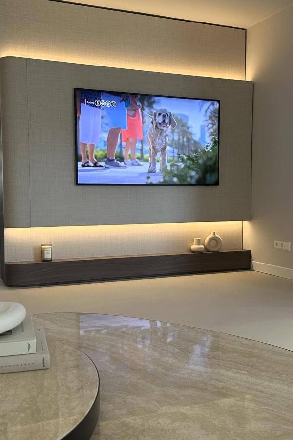 Backlit media wall creates cozy depth, enhancing media wall ideas.