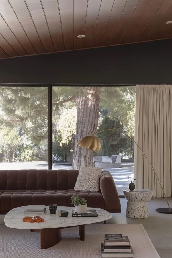 Luxurious room featuring floor-to-ceiling windows with plush velvet seating.