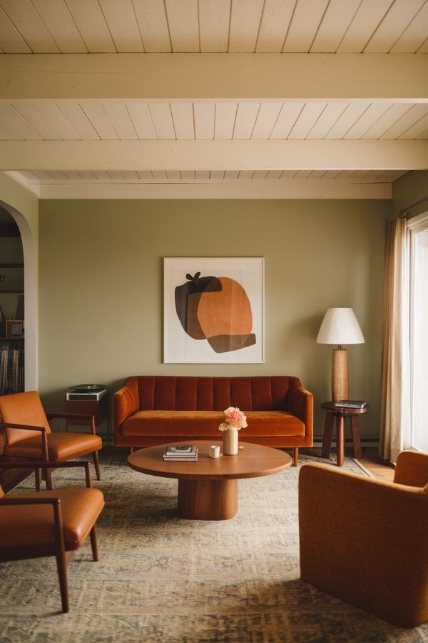 Vintage-style living room filled with earthy green tones and warmth.