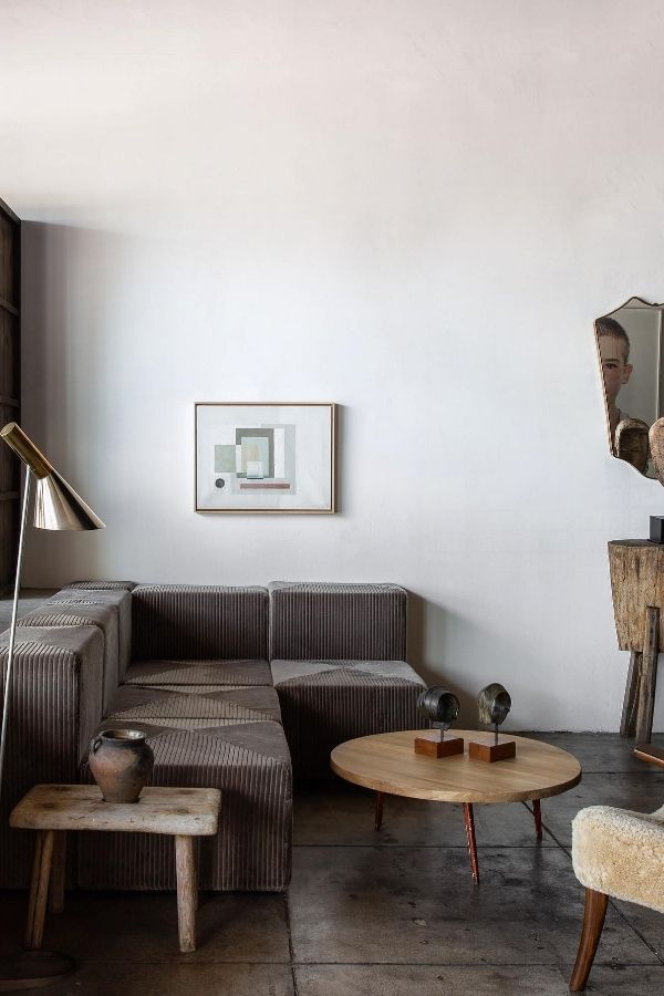 Industrial-themed space featuring muted neutral tones and modern metal accents.