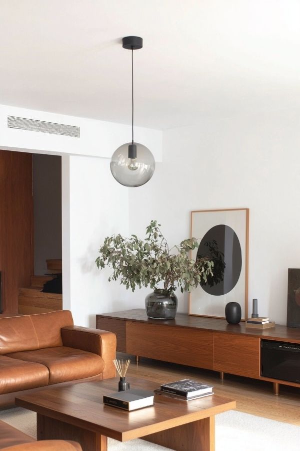 Sleek design featuring warm leather contrasted by minimalist black accents.