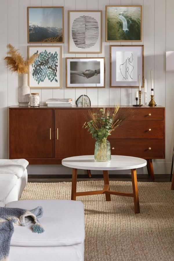 A minimalist room featuring elegant framed artwork on white walls.