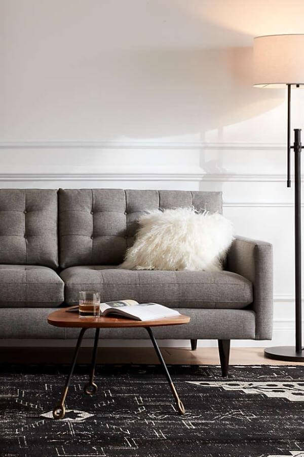 Gray tufted sofa from Wayfair, blending elegance with Scandinavian minimalism in mid-century modern design.
