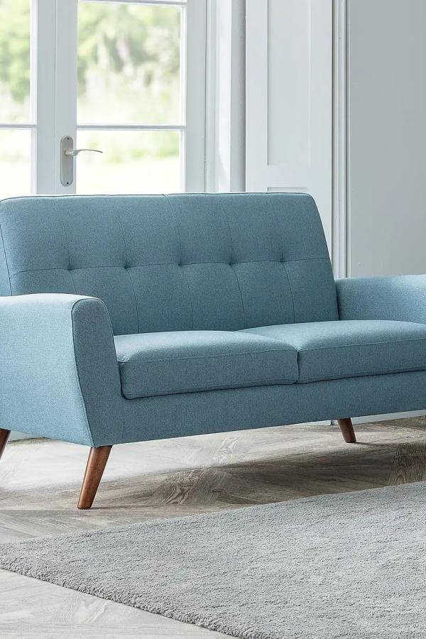 Pastel blue mid century modern sofa from Crate & Barrel, exemplifying sophisticated simplicity in a chic setting.