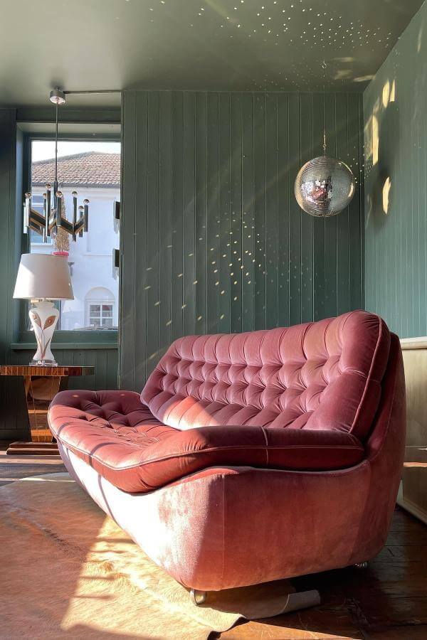 Silver disco ball centerpiece in living room from All Modern; complements the stylish mid century modern sofa.