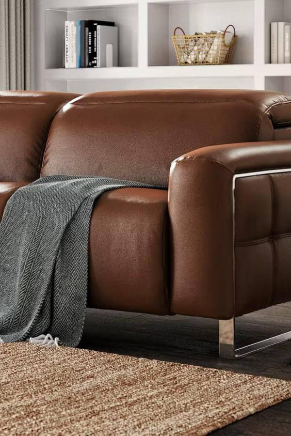 Brown leather sofa with sleek metal accents from @vinestreetvintage. Inspired by mid century modern sofa design ideas.