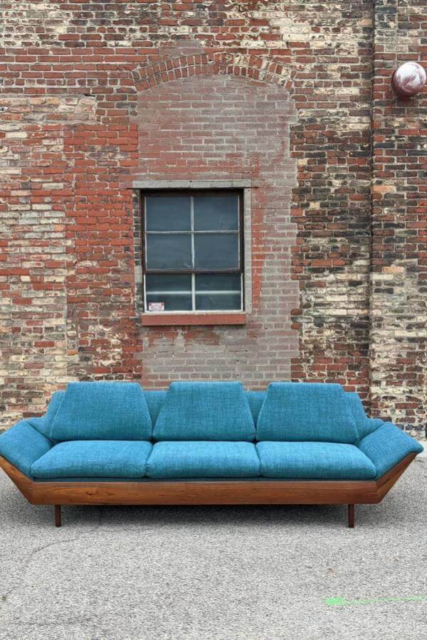Teal and brick living room featuring a mid century modern sofa from @ben_sounds, exuding a stylish retro vibe.