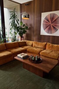 Sunset velvet hues grace a modern 70s living room charm.