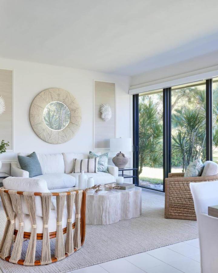 Woven rope chair and driftwood table in bright modern coastal living room ideas by @allywhalendesign with soft blue and natural tones.