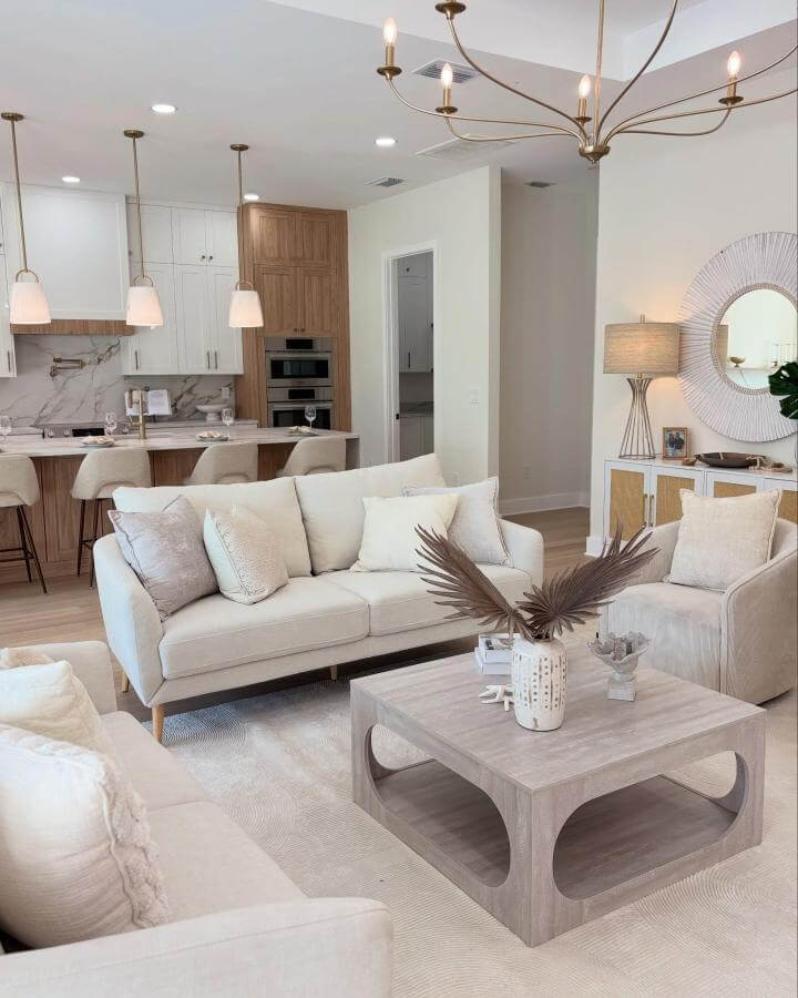 Beige and wood tone living room with neutral soft furnishings and dried palm centerpiece by @strategic_staging. Modern coastal inspired interior with natural textures.