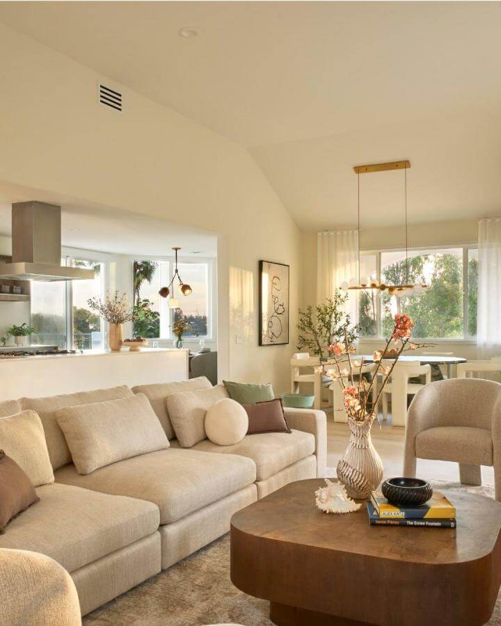 Soft beige and cream coastal living room with curved furniture and natural accents from @liveprivemalibu showcasing warm, inviting design.