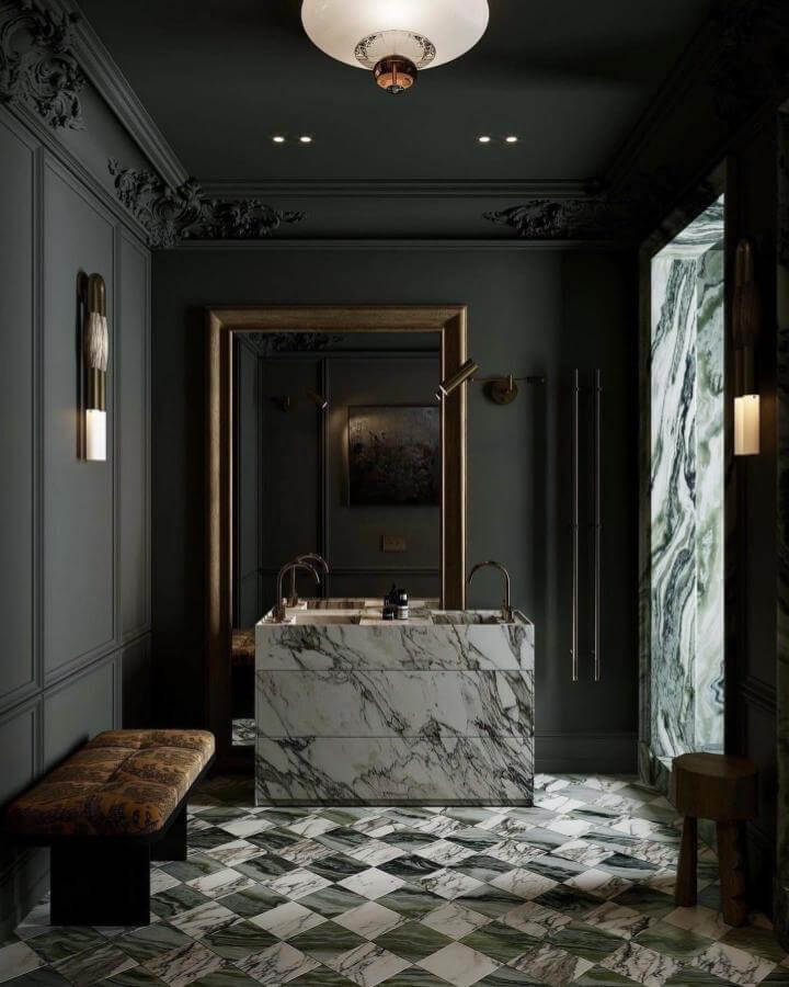 Marble sink and floor with dark green walls and gold accents in a moody bathroom by @nora_chou_. Elegant and dramatic moody bathroom ideas.