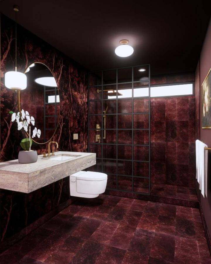 Deep maroon tiled bathroom with black grid shower and floating stone sink from @jenniferlopezdesigns showcasing moody bathroom ideas with rich textures and dark tones.