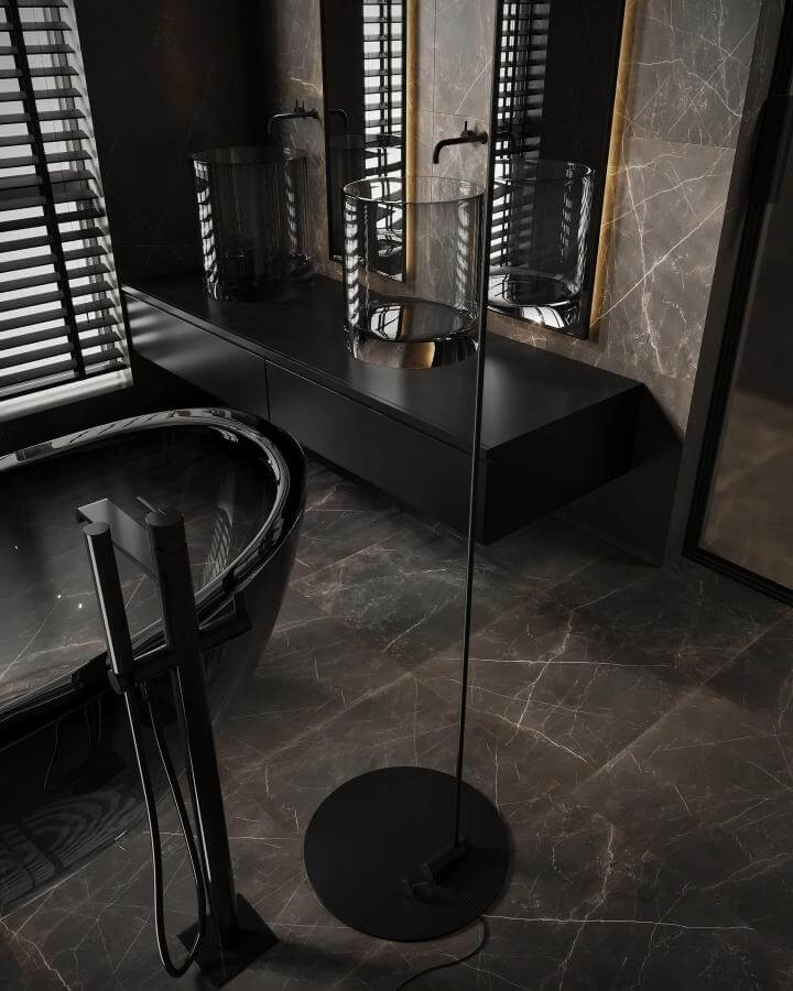 Black marble bathroom with glass vessel sink and sleek modern fixtures by @siiminsalahzadeh. Dark tones with subtle lighting.