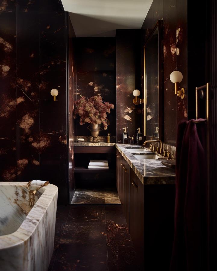Dark marble bathroom with gold accents and creamy marble tub from @gildedhearth. Luxurious and atmospheric deep tones with vintage vibes.
