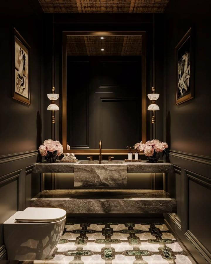 Dark stone sink and floating countertop in a moody bathroom ideas design by @falaknumavisuals with soft lighting and floral accents.