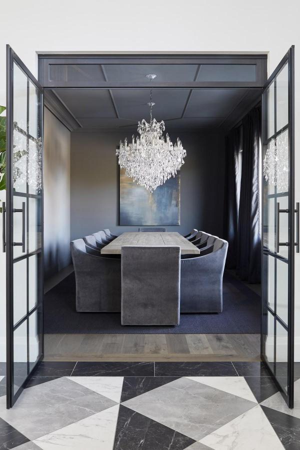 Moody dining room with dramatic chandelier; explore moody dining room ideas.