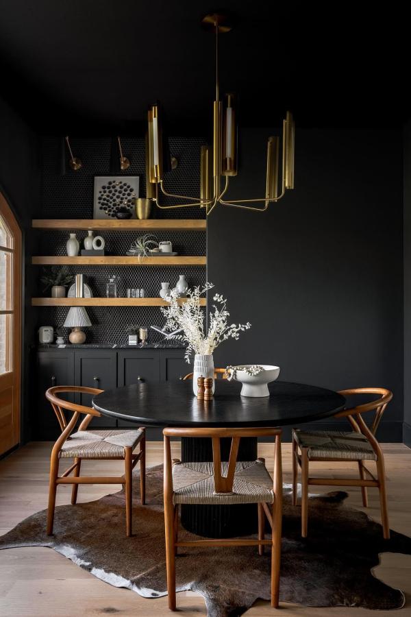 Moody dining room ideas: Elegant space with gold chandelier focus.