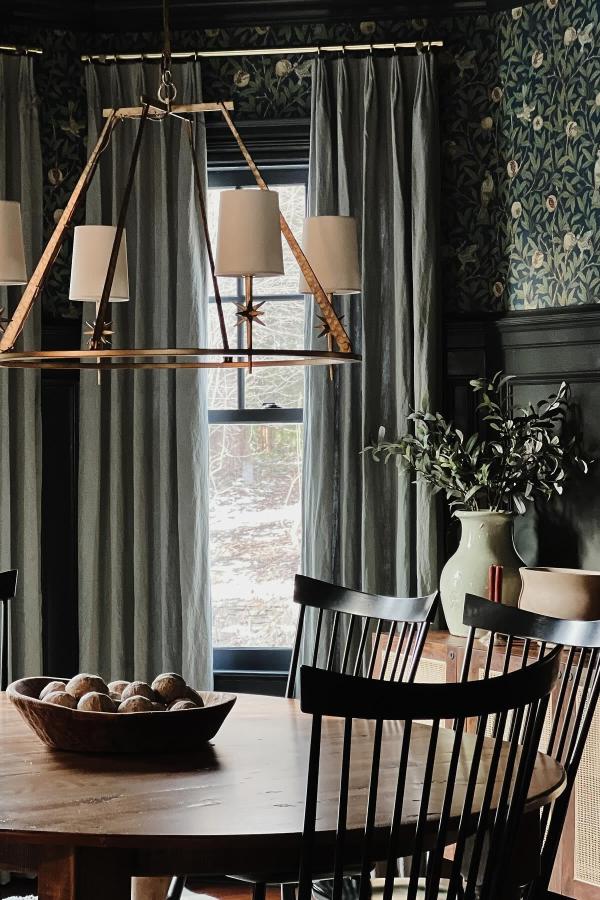 Moody dining room featuring striking chandelier; explore moody dining room ideas.