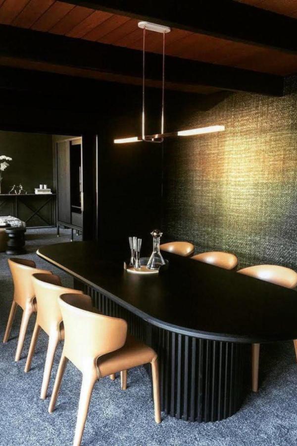 Moody dining room ideas with a sleek black dining table ambiance.