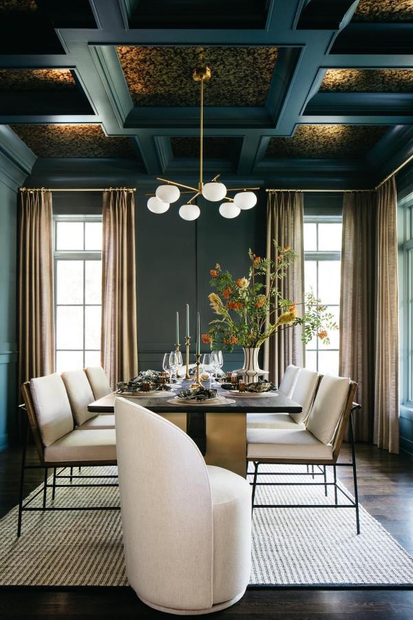 Moody dining room ideas: dramatic coffered ceiling, elegant lighting, dark tones.