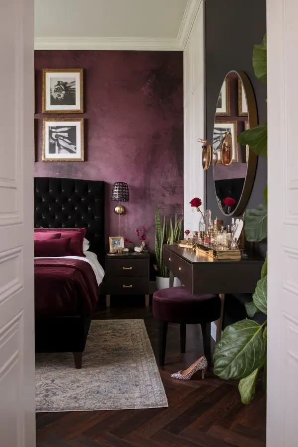 Moody romantic bedroom with dim lighting, plush pillows, and candles.