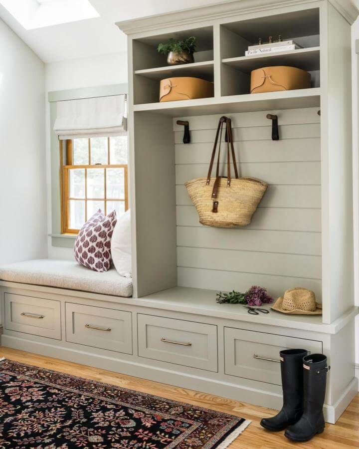Soft green built ins with bench seating and storage by @joyellewest showing practical and stylish mudroom built ins ideas.