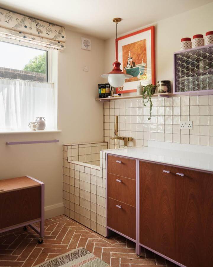 Cream tiled mudroom dog wash ideas with warm wood cabinets and lilac trim from @thepropertyphotographerltd. Stylish and functional pet cleaning space.