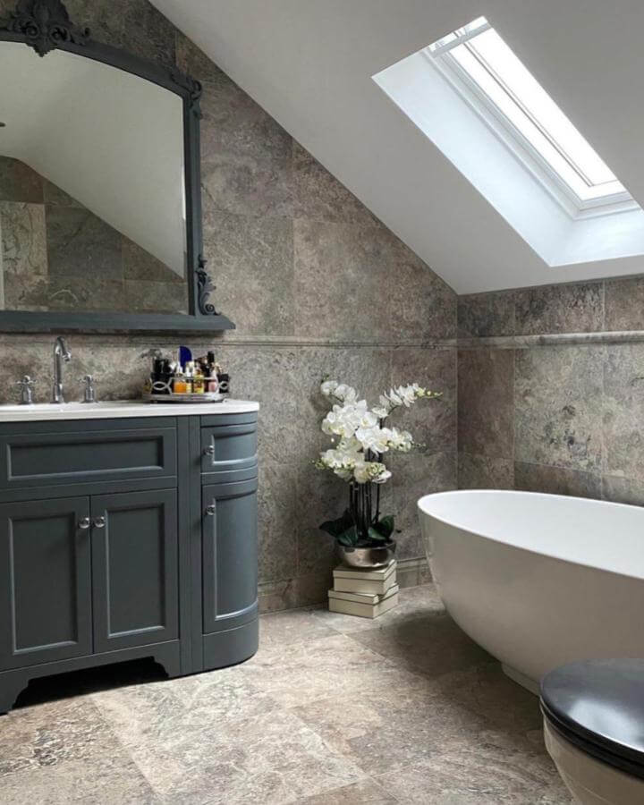 Neutral grey natural stone bathroom with Opulence stone resin bath and classic vanity from @thetilecompanyltd. Calm, textured natural stone bathroom ideas.