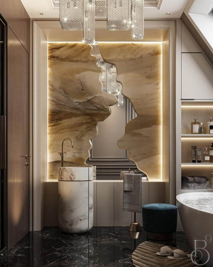 Warm beige onyx wall with marble pedestal sink and black marble floor in bathroom by @covetgroup natural stone bathroom ideas sculptural and elegant