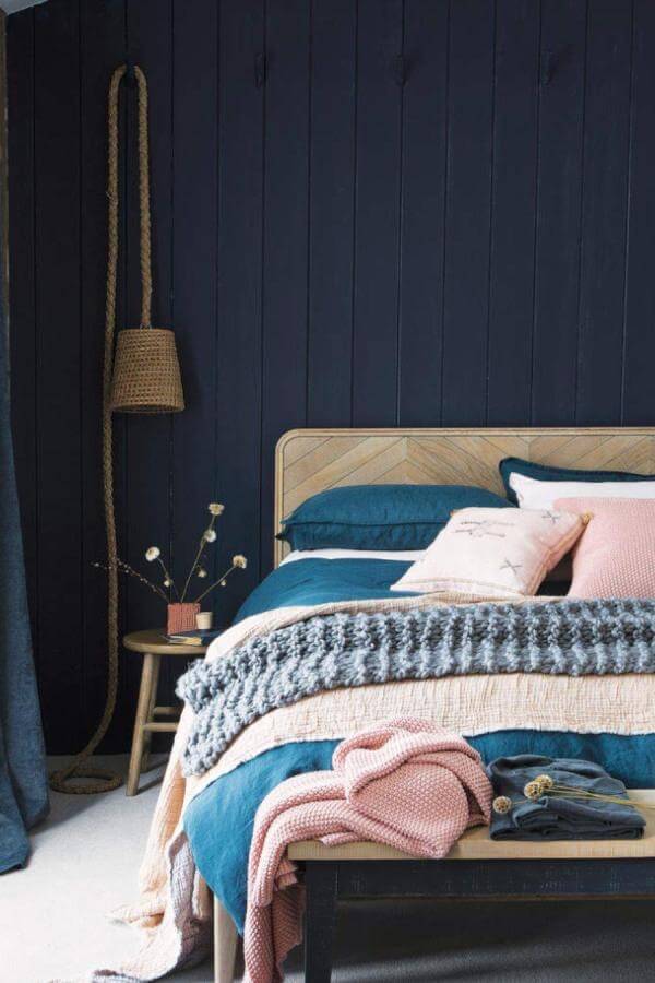 Cozy navy walls with handcrafted rope lighting in a stylish bedroom from @idealhomeuk. Warm, inviting atmosphere.