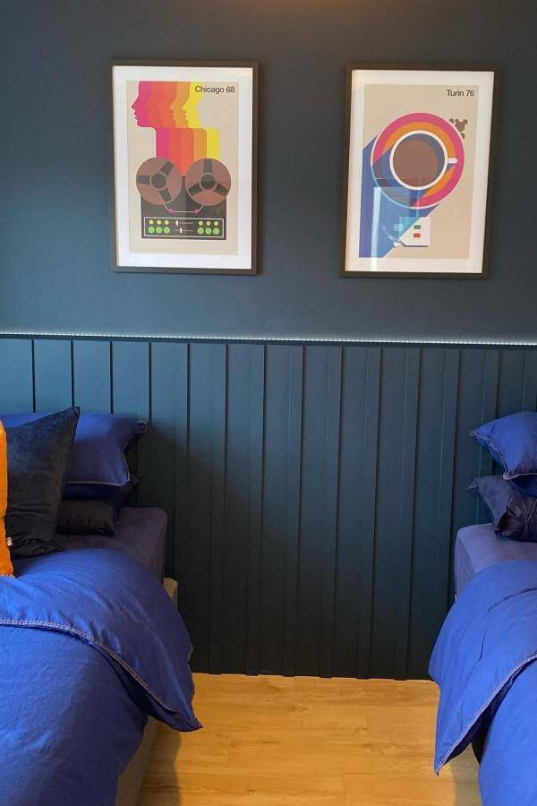 Bold navy wall art from @janedennehyinteriors, adding retro magic to stylish bedroom decor.