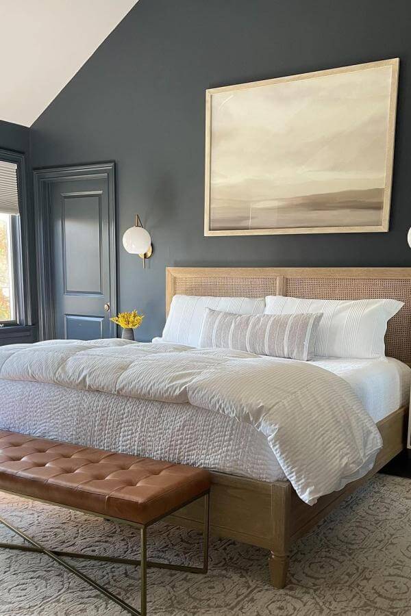 Woven natural fiber headboard from @melissafisherhome. Contrast beautifully with moody navy walls in stylish navy bedroom ideas.
