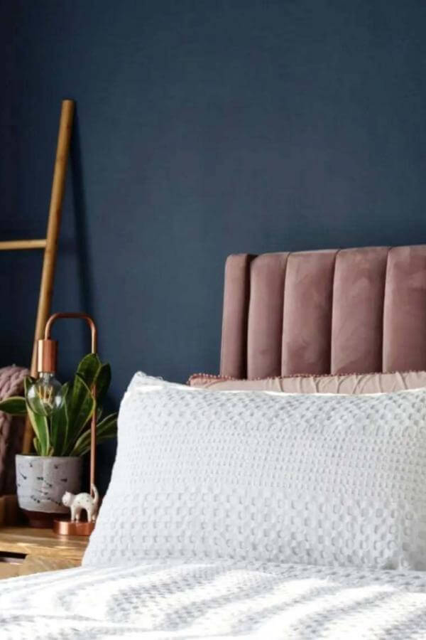Blush velvet headboard from @thepimlotts pops against navy walls, perfect for chic navy bedroom ideas.