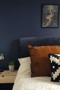 Rust-toned velvet pillow from @housefifty5. Adds warmth and complements navy bedroom ideas beautifully.