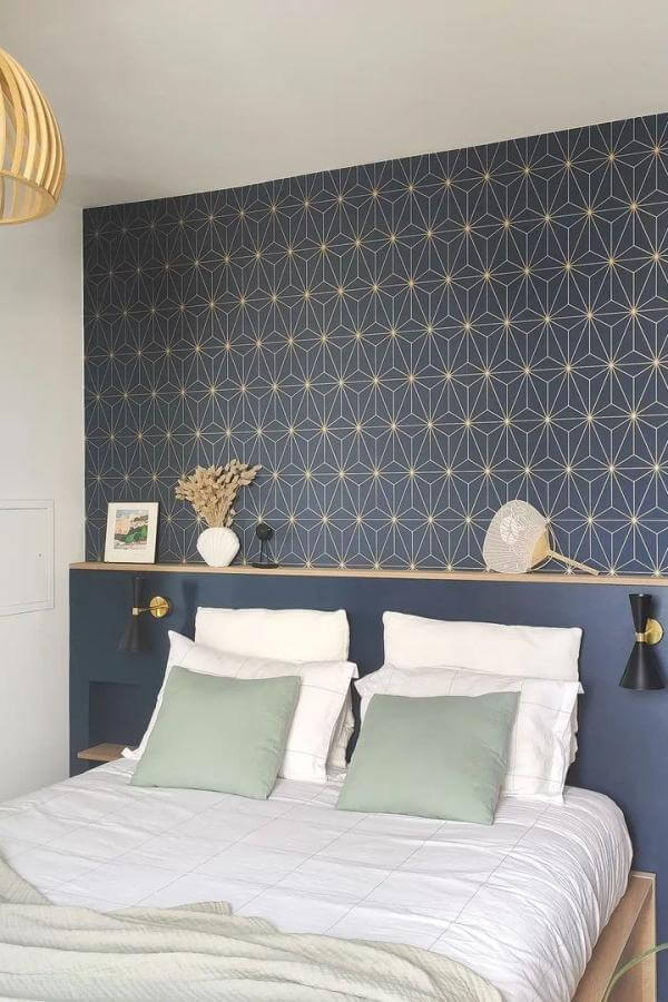 Geometric navy accent wall from @grahamandbrown. Bold pattern steals the show in stylish modern bedroom.