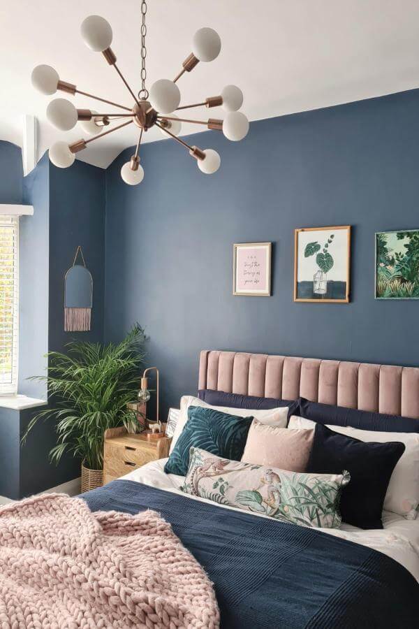 Soft blush velvet headboard in navy bedroom from @thepimlotts softens deep navy walls beautifully.