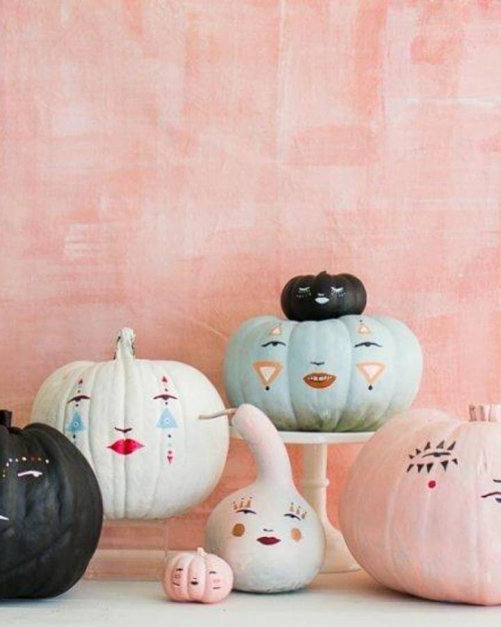 Pastel painted pumpkin faces showcasing creative no carve pumpkin ideas from @craftgawker with geometric facial features