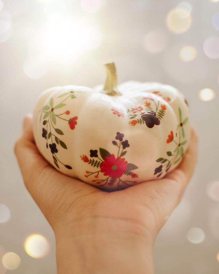 Floral decoupage white pumpkin craft from @littles_of_mine. Delicate botanical patterns in red and green hues.