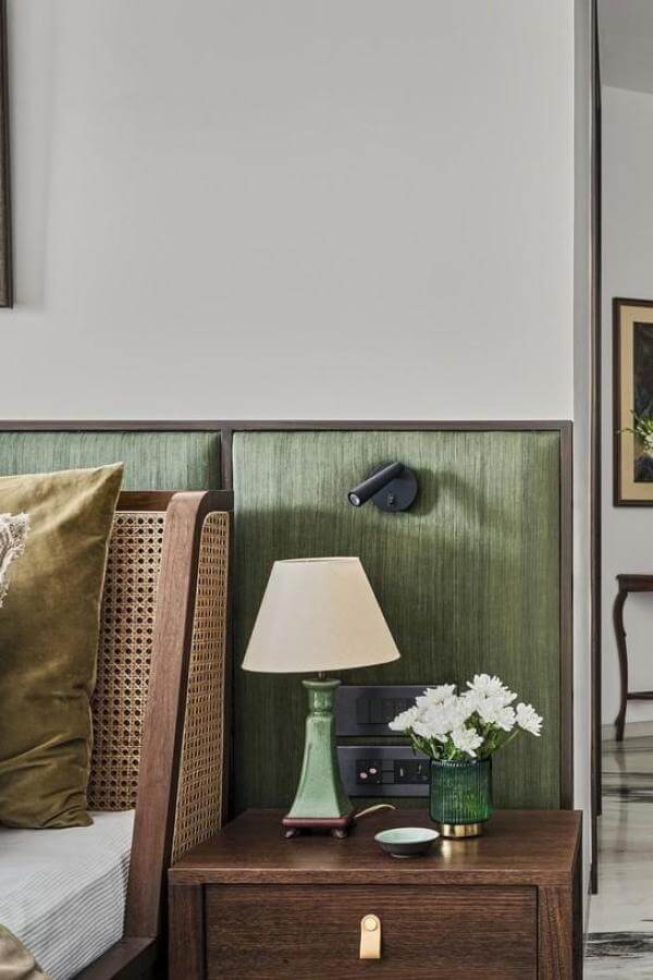 Olive green rattan headboard from @deshnakasliwal. Adds natural charm to olive green bedroom ideas.